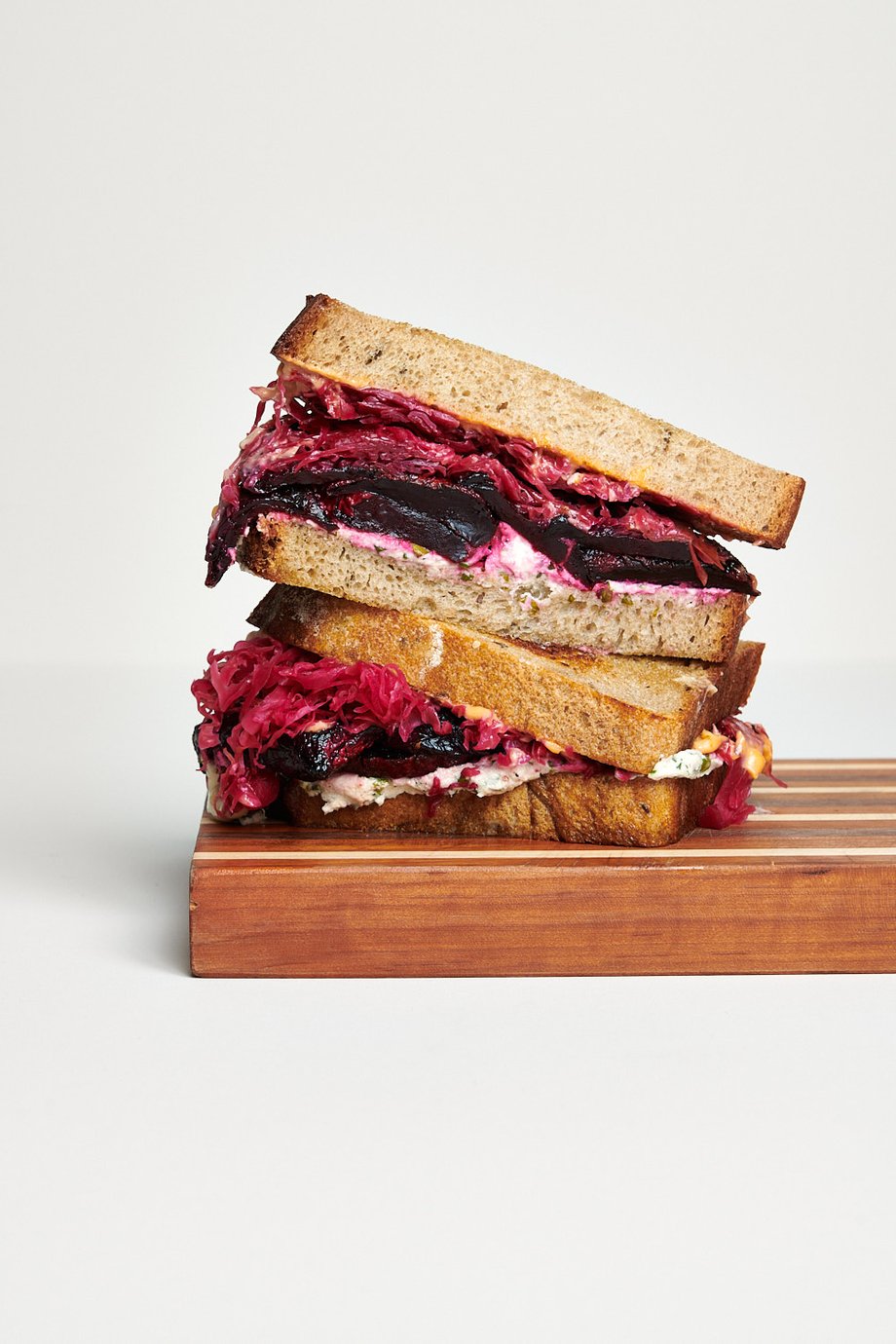Dina Avila photographs a scrumptious beet sandwich on a white backdrop for Fermenter