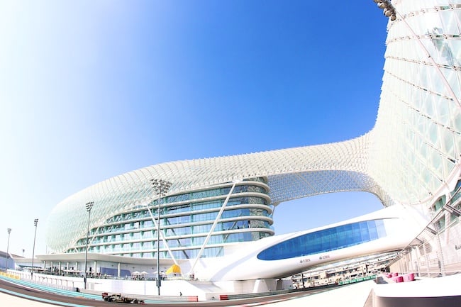 Exterior of the Yas Marina Circuit, with a race car in sight 