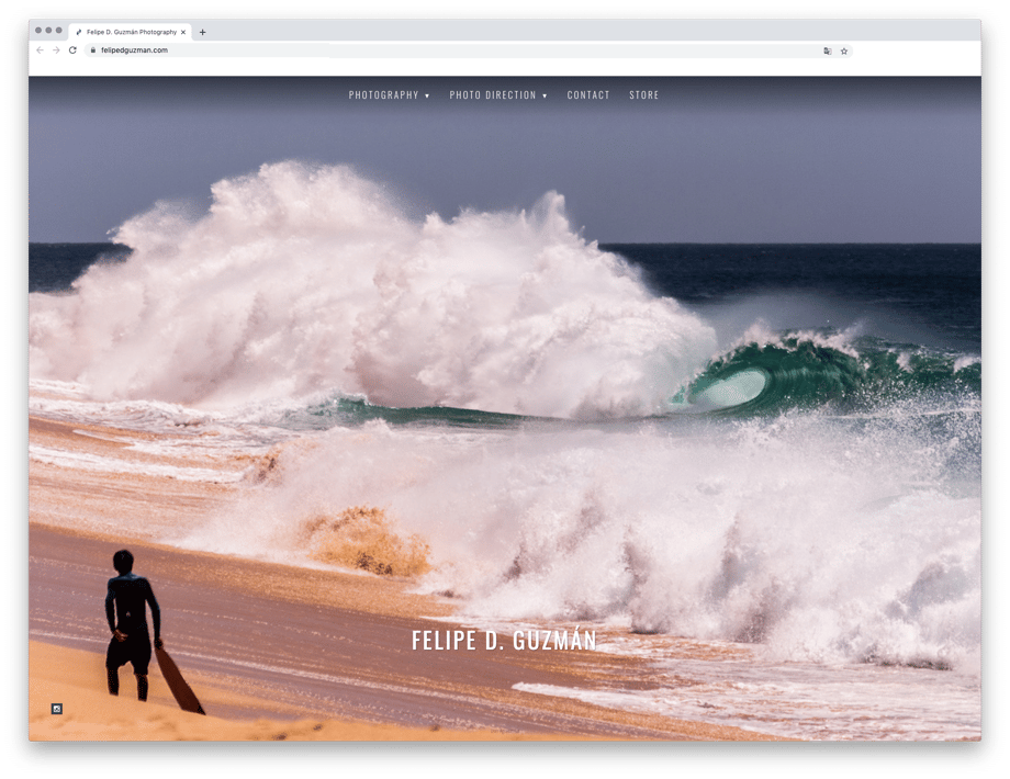 Front page of Felipe Guzmán's website showing a photo of a surfer looking at a large wave.