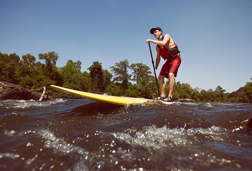 Adventure and Outdoor photograph of stand-up paddle-boarder
