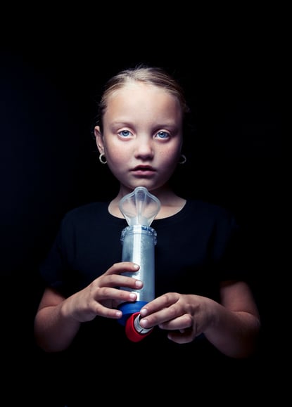 A young girl with an inhaler and spacer shot by Los Angeles-based portrait photographer Kyle Monk for Cystic Fibrosis Foundation 