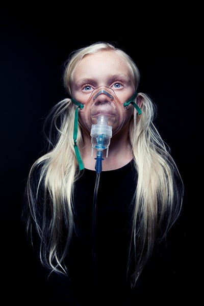 Child wearing a mask-attachment for a breathing treatment machine shot by Los Angeles-based portrait photographer Kyle Monk for Cystic Fibrosis Foundation 