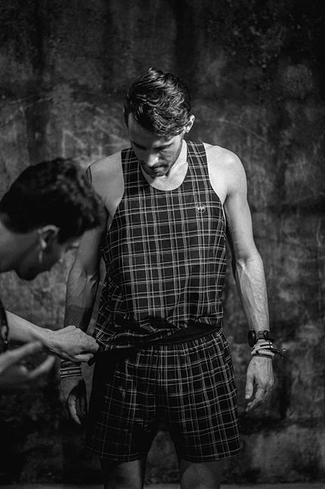 Ian MacLellans black and white photo of a man being dressed in checkered Janji apparel