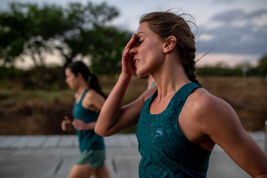 Ian MacLellans photo of women running on the road wearing teal Janji apparel