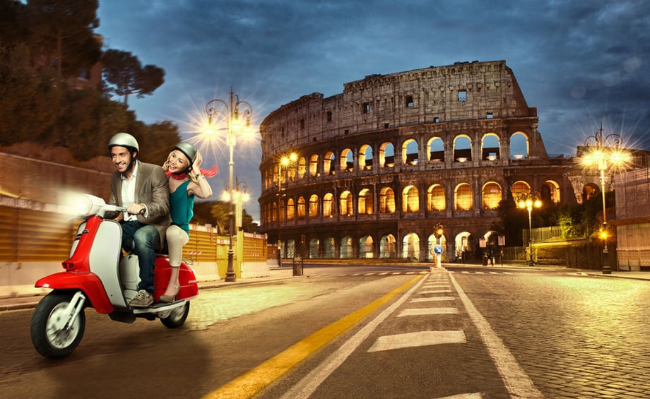 Francesco Ridolfi (AKA Felix Reed) photographs a couple riding a scooter by the colosseum in Rome, Italy.