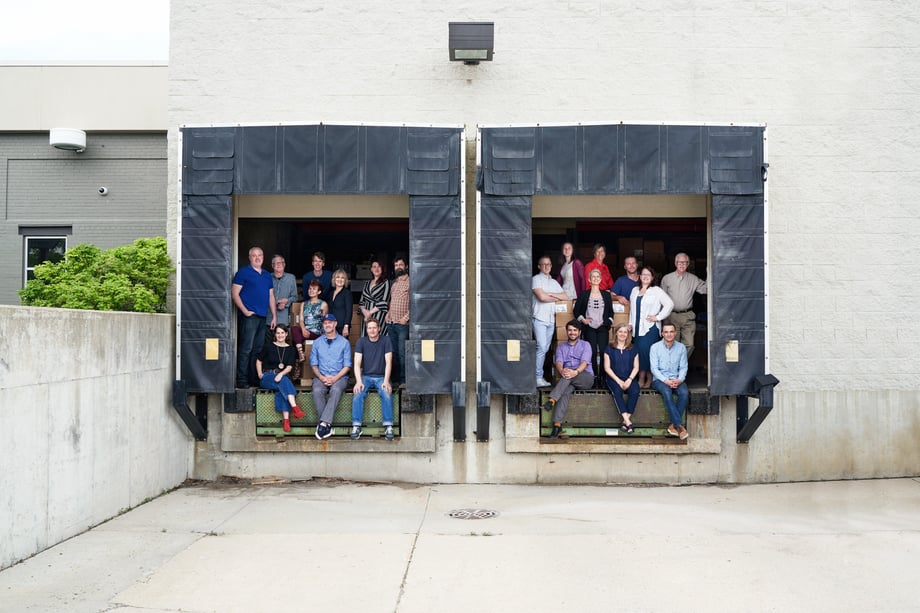 Kat Schleicher's staff photo of Porchlight's workers sitting in the truck bays at their loading dock