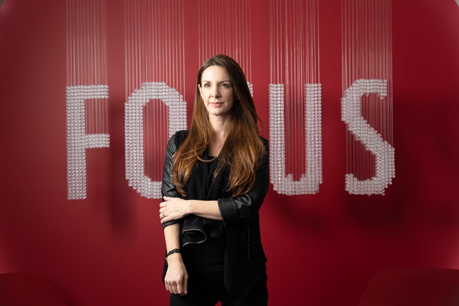 A second candid shot of Kat Cole in front of the blurry FOCUS sign