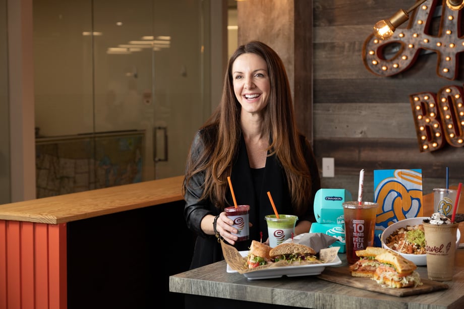 Kevin Heagney catches a candid shot of Kat Cole sitting at a table with a display of fast food