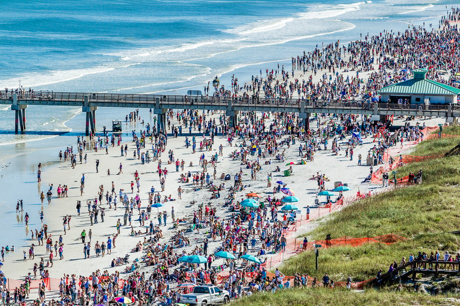 Aerial image of a busy beach and pier by Ryan Ketterman