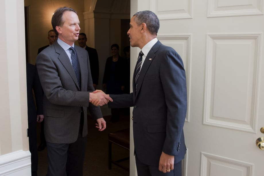 Photograph of political photographer Brooks Kraft shaking hands with Obama at a white house meeting.