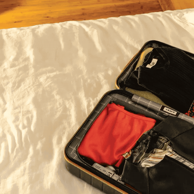 Gif for DVF showing items of clothing being efficiently packed into a suitcase.