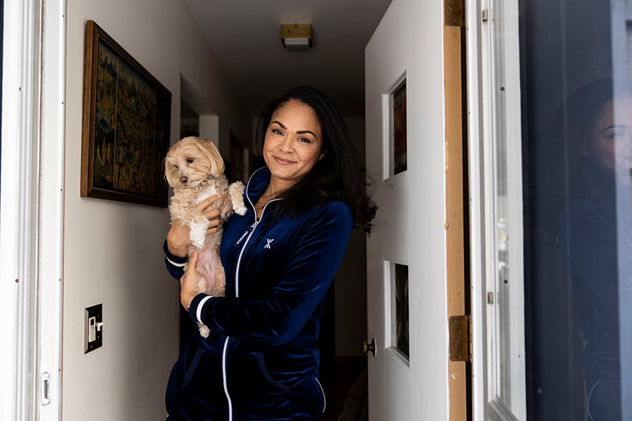 Karen Olivo holds her dog while at home in Wisconsin. Photographed by Lauren Justice for The New York Times. 