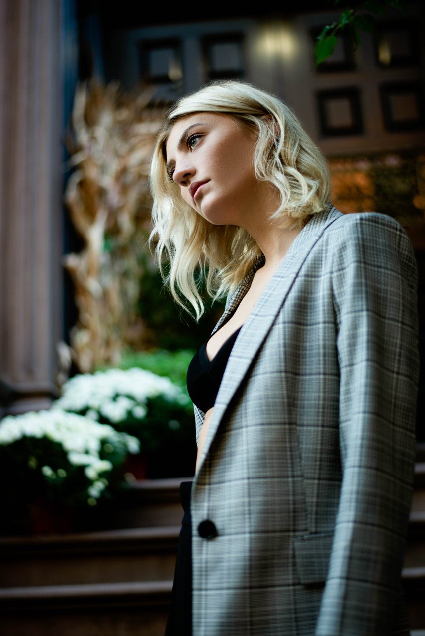One of Kate Holliday favorite photos shows a young woman in a plaid sports coat at an entryway with flowers