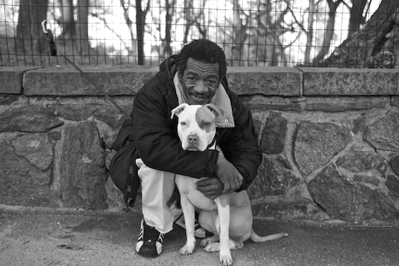 Photograph by Lou Bopp of an older man with a pit bul