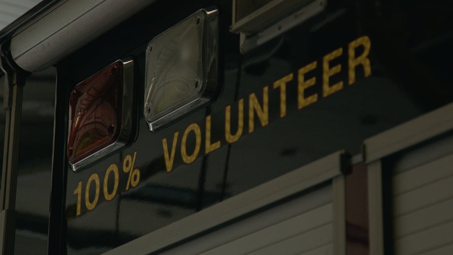 Josh LeClair gets a close up of the words "100% Volunteer" below the lights on a firetruck