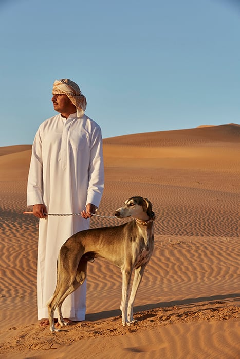Martin Westlake photographs dog and handler in the desert for DestinAsian