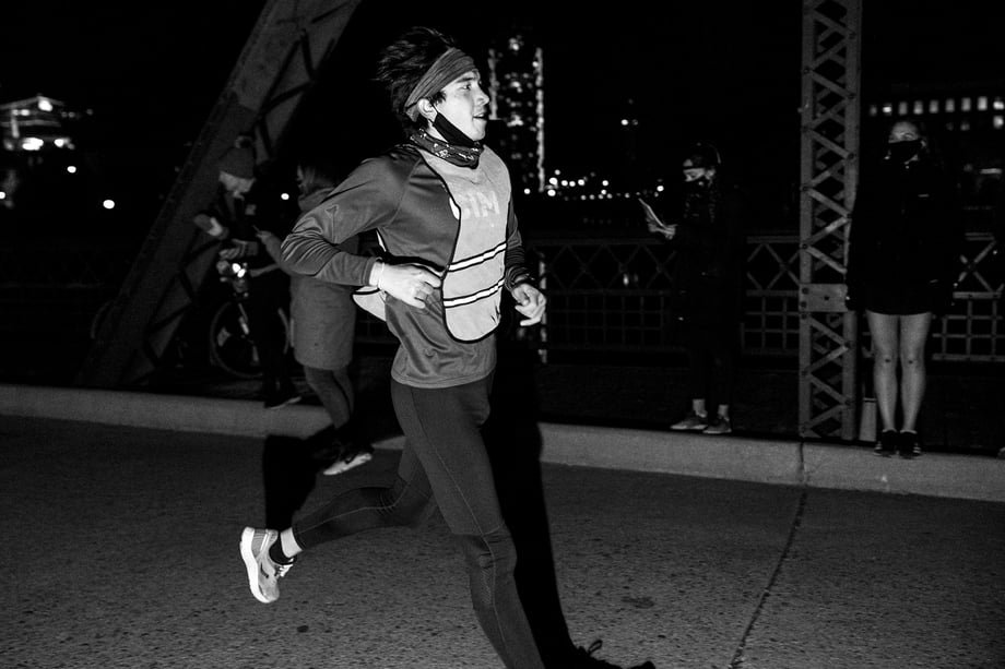 Matt Trappe photographs runner at the finish line tired and in the dark for TTB in Denver