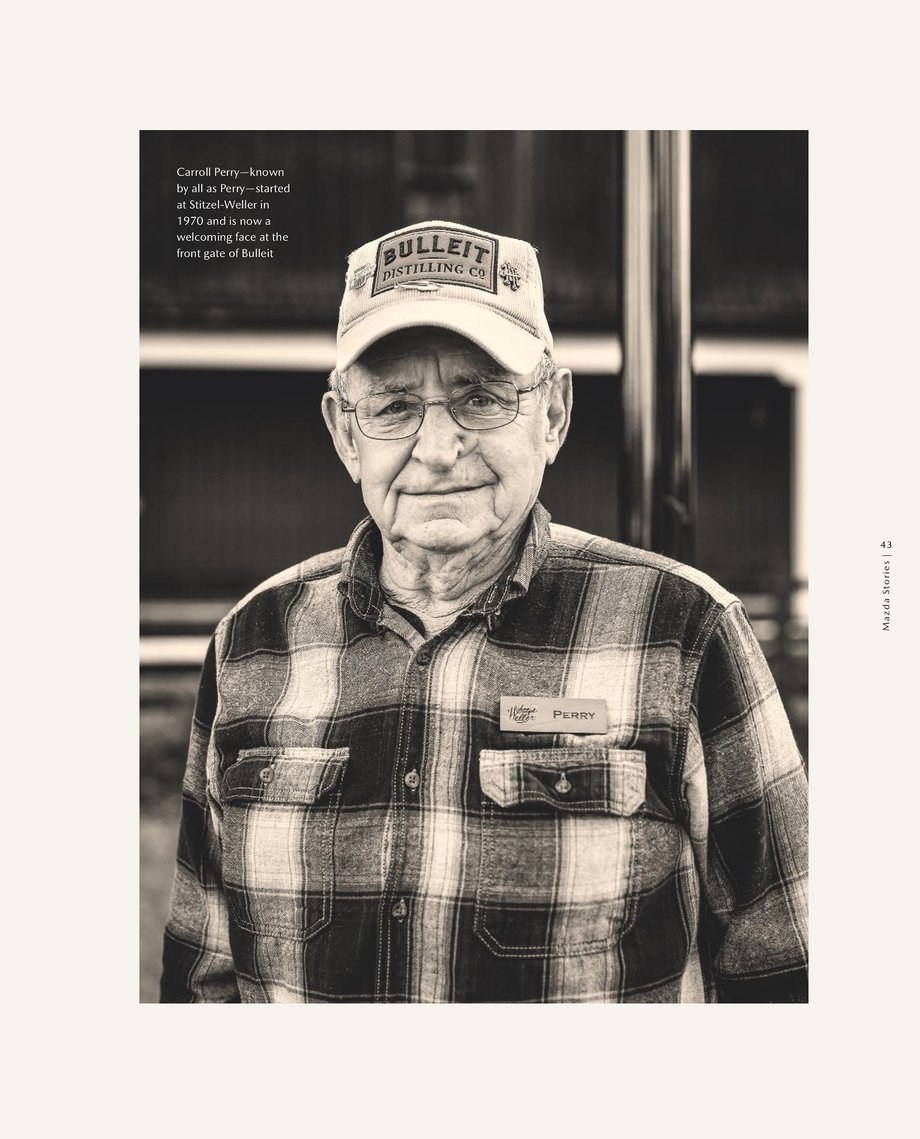 Portrait of Perry, an older gentleman in a plaid shirt with a baseball cap that says Bullet distilling co.