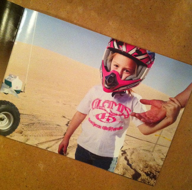 Portrait of a child wearing a biker helmet, shown on the back of an print promo