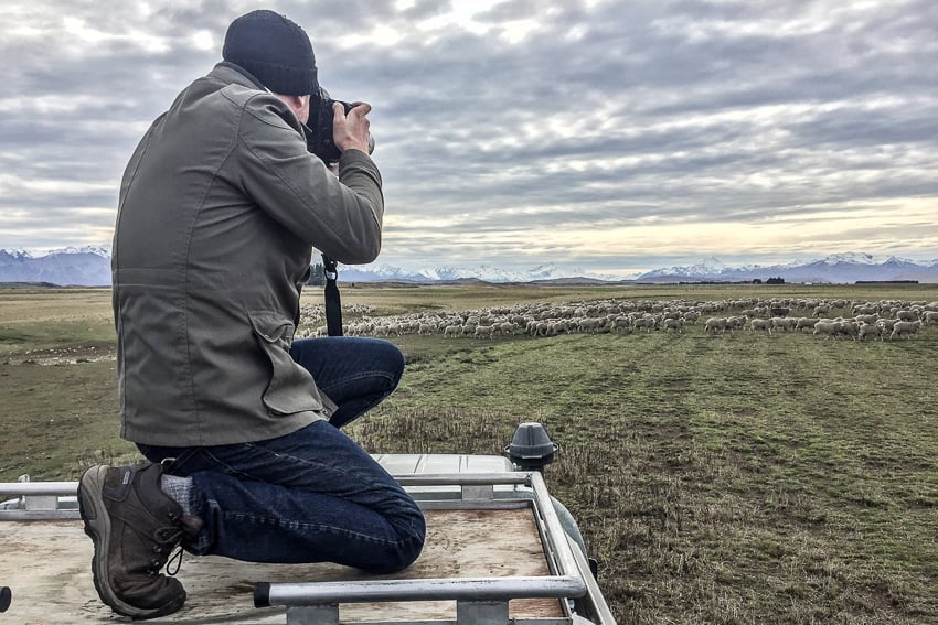 BTS photograph of Tadd Myers photographing sheep in New Zealand