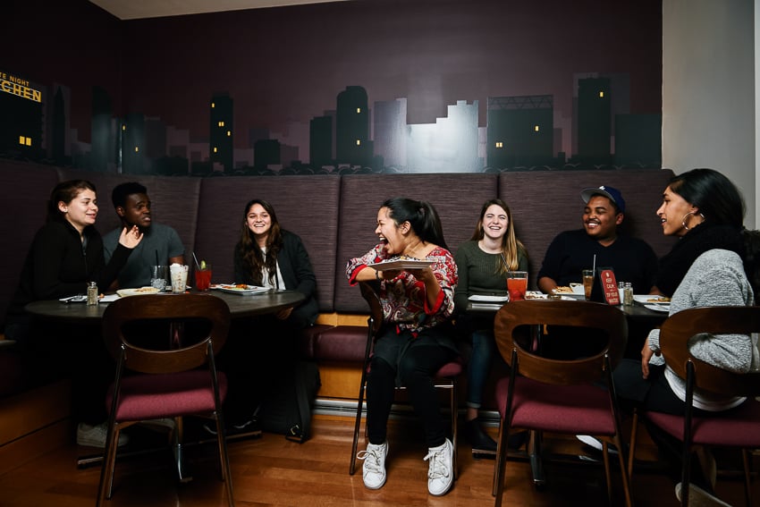 Doug Levy's Photograph of people eating and smiling in BU cafeteria. 