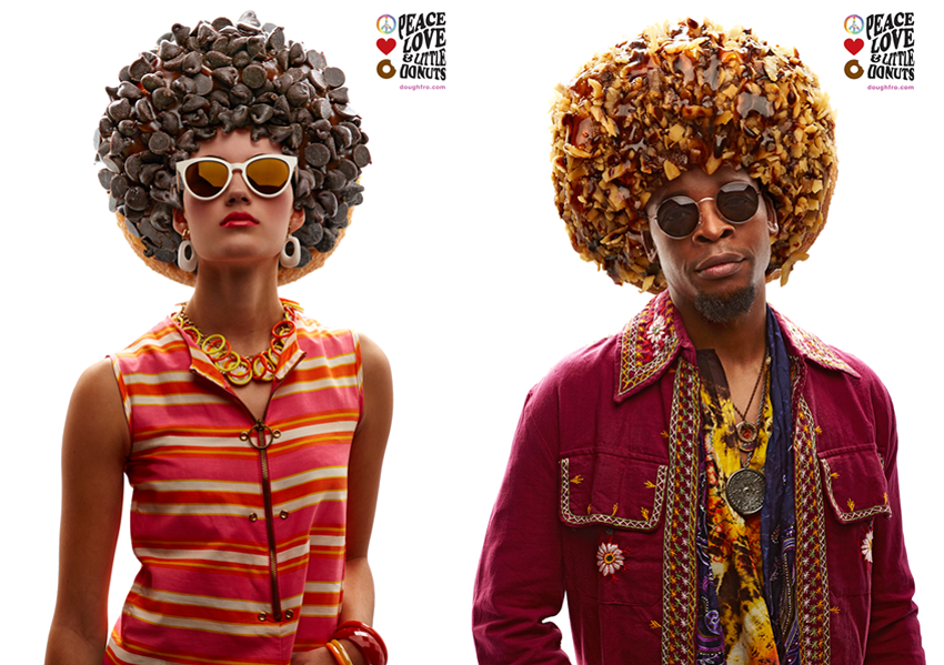 Photo by Tom Cwenar for Brunner Works of two models dressed in vintage 70s attire with donuts in place of their hairstyles.