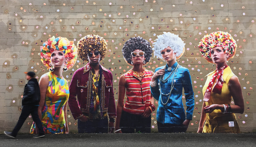 Mural based on photo by Tom Cwenar for Brunner Works of models dressed in vintage 70s attire with donuts in place of their hairstyles.
