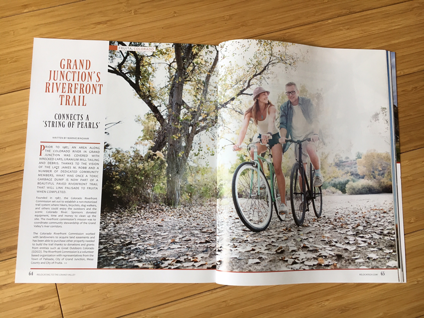 inside  pages of Relocating Magazine showing a tearsheet of the image of the two people riding bikes