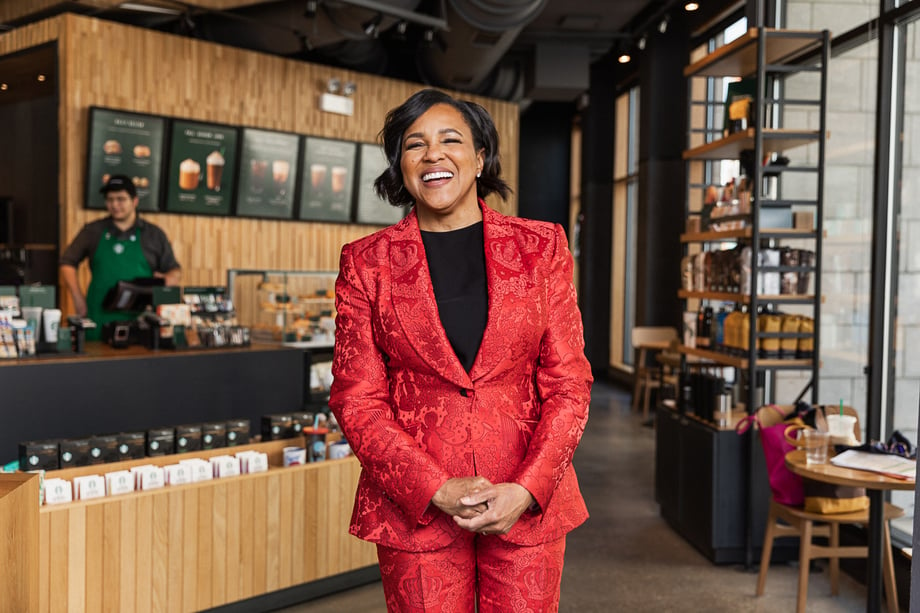 Roz Brewer stands in the lobby of a Starbucks in this portrait by Sara Strathas