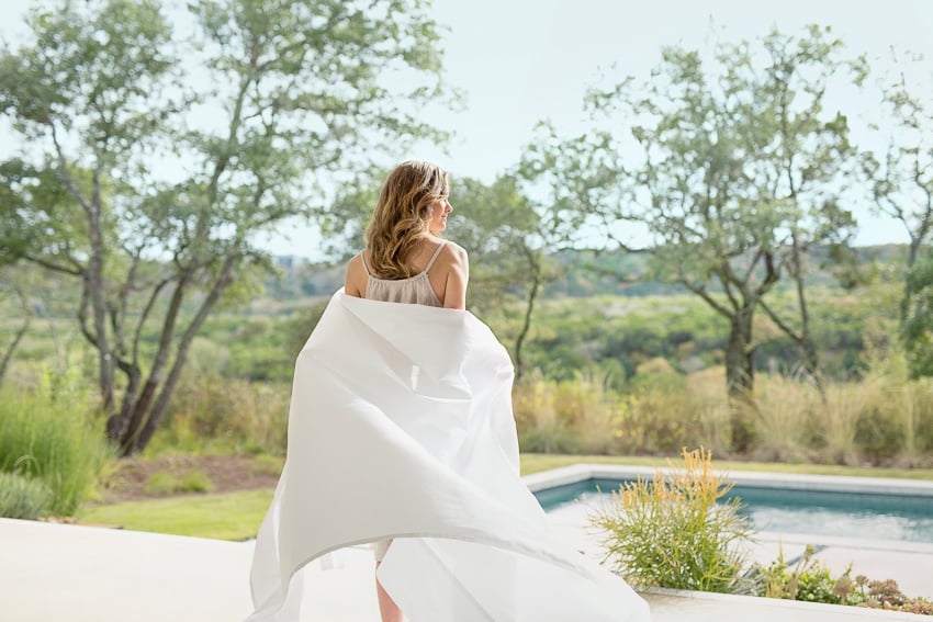 Photograph a model walking outside towards a swimming pool in a Saatva sheet for Saatva Dreams by Buff Strickland.