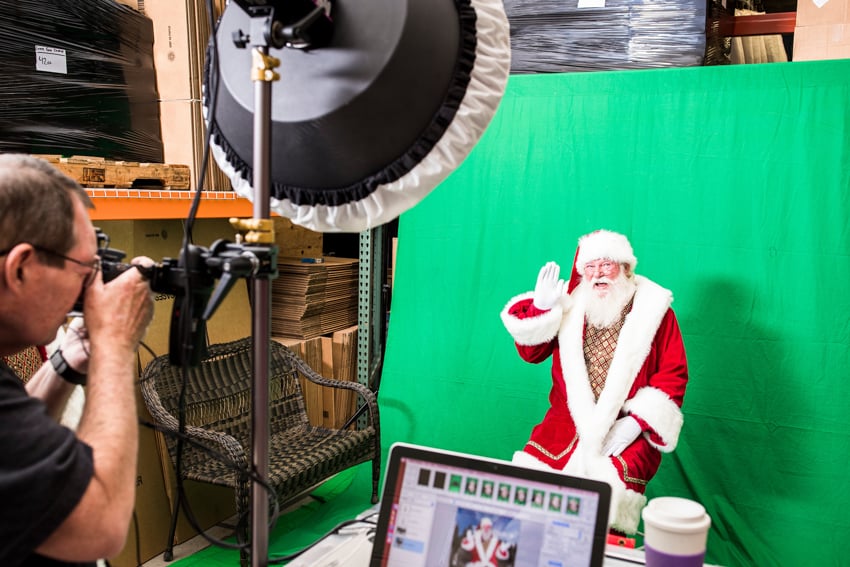 Tear sheet of Sayre based photographer Brett Carlsen taking a photo of Santa.