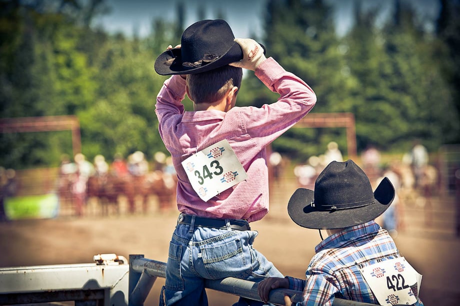 Kids looking on at the rodeo photographed by John Sibilski