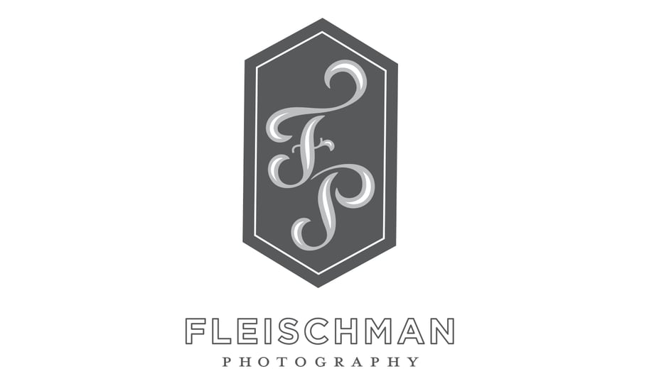 cursive Initials in a grey diamond-like shape above fleischman photography