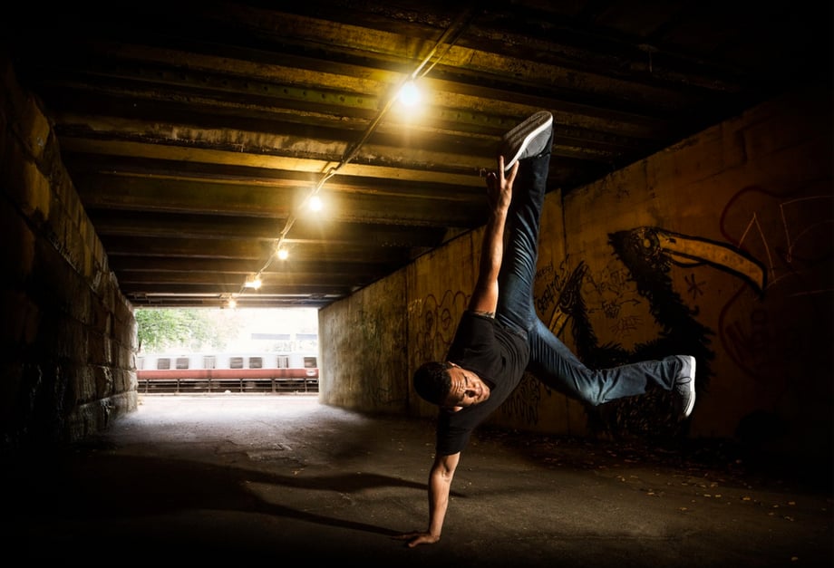 Photo of a man break dancing in a tunnel in Boston, photo by Josh Andrus