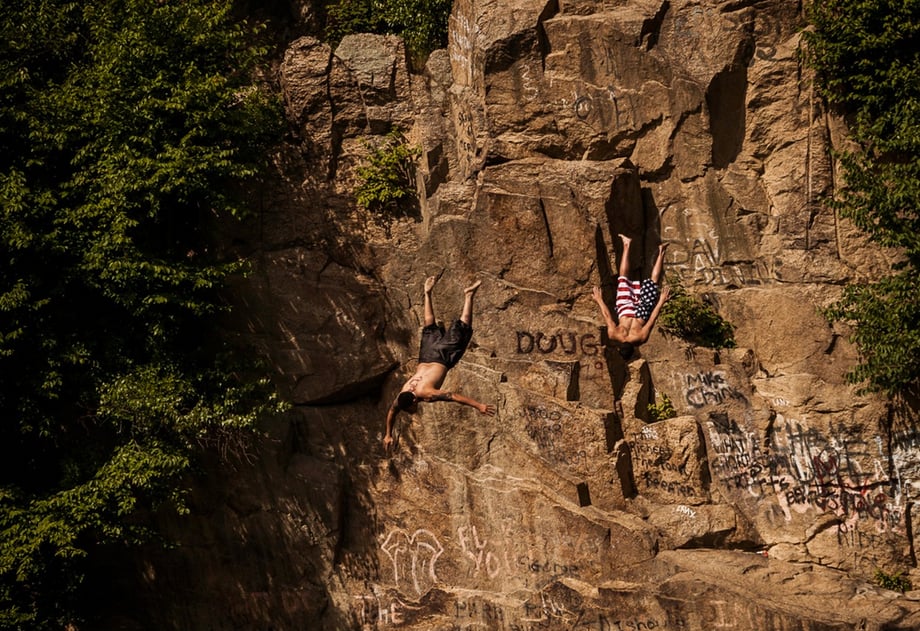 Two young men dive head first into a quarry, photo by Josh Andrus