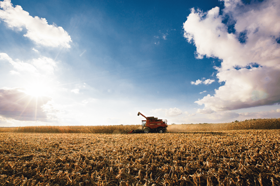 Agricultural photography showing a tractor in an open field, by Geoff Johnson