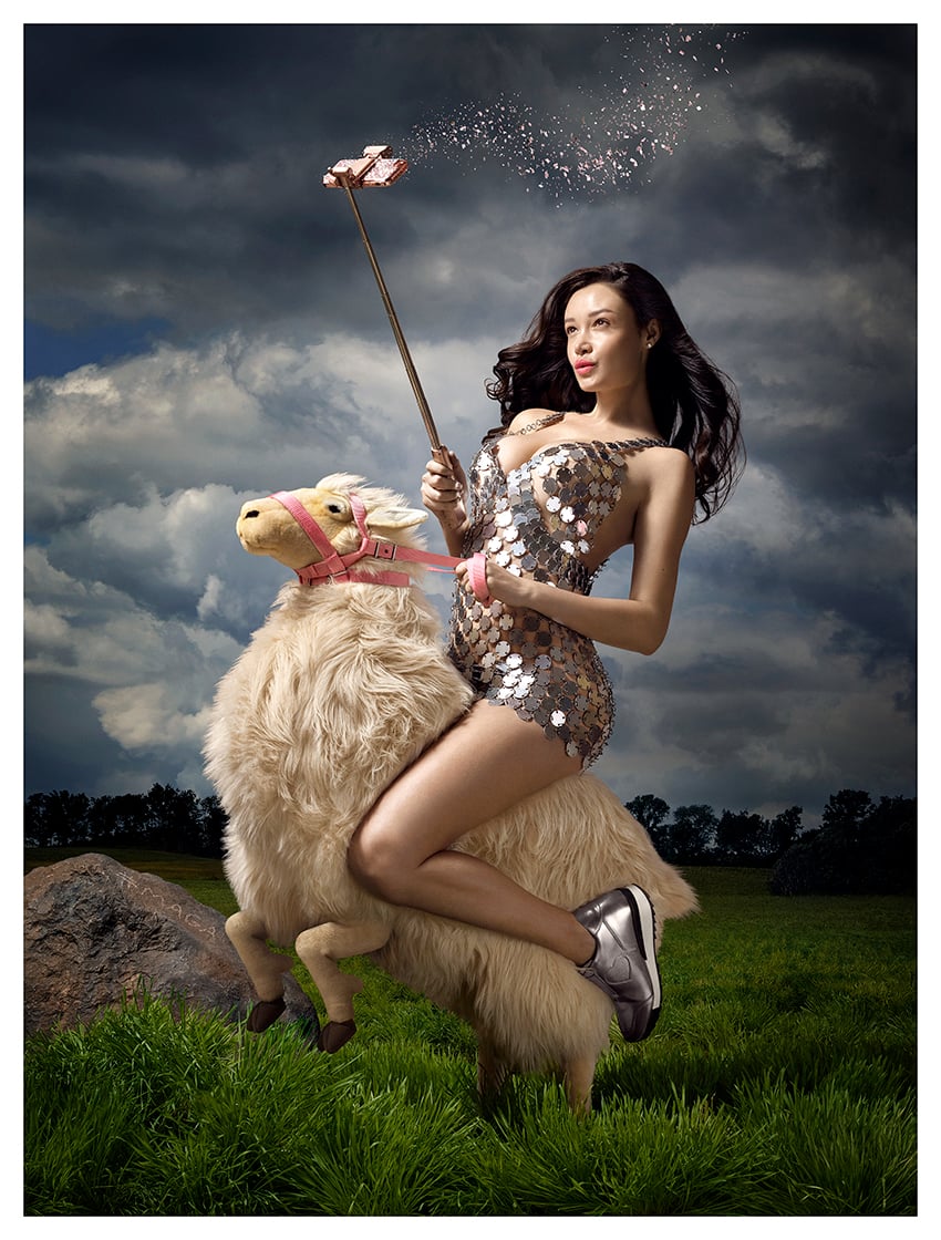 Dror/Forshée's photo "Selfie" shows a woman in a seqined dress riding a stuffed sheep, using a selfie stick