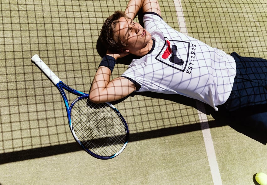 Photo of model shooting for Fila on tennis court shot by photographer Stanislav Solntsev.