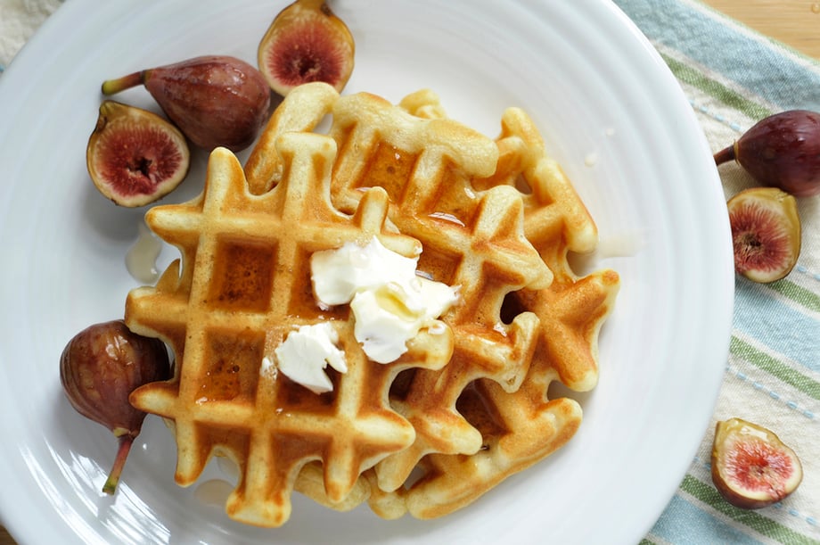 An up-close image of a waffle smothered in butter