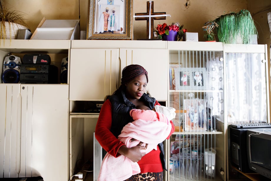 Tina Boyadjieva for Lansinoh photographs an African mother in her home as she breastfeeds her baby