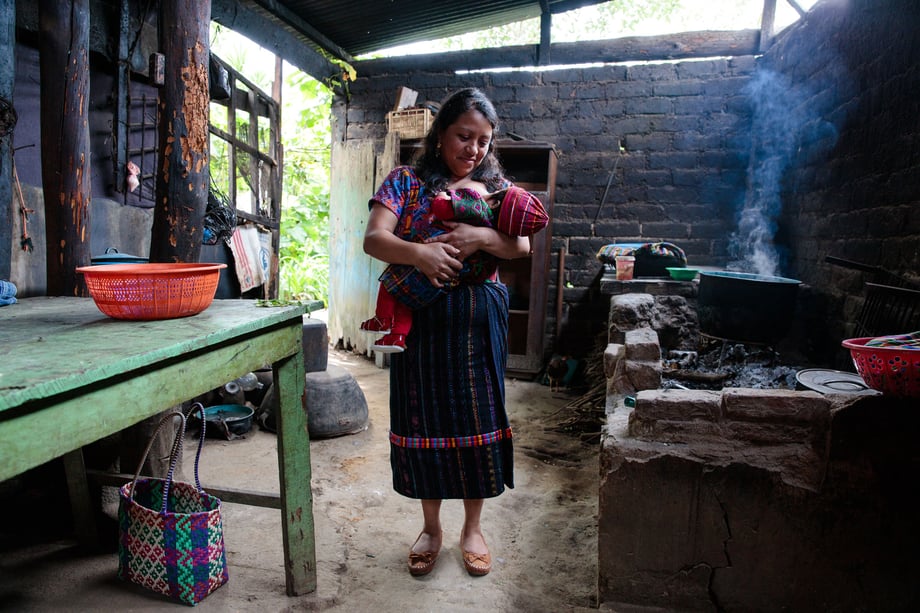 Tina Boyadjieva heads to Guatemala to photograph a mother breastfeeding in a beautifully rustic kitchen with an open fire and a chicken for Lansinoh