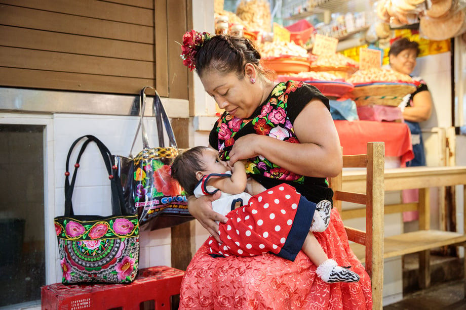 Tina Boyadjieva photographs a mother breastfeeding her adorable baby in a market in Mexico for Lansinoh