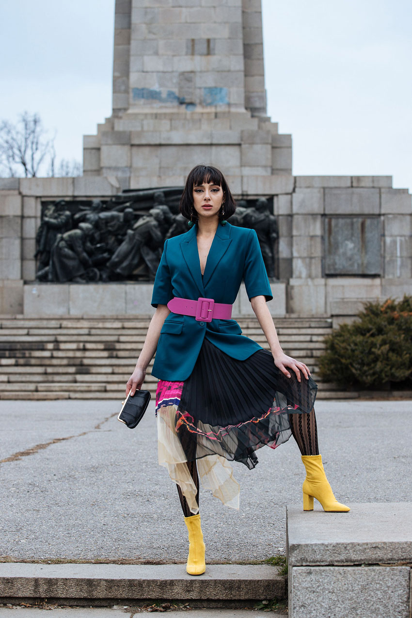 Tina Boyadjieva's model in bold colors standing at the foot of the Bulgarian monument of Russian Liberators