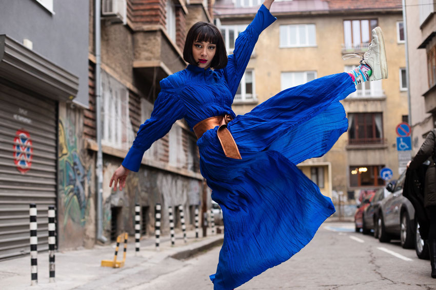 Tina Boyadjieva shows her model in a flowing bright blue dress at the school in Sofia where she first learned English