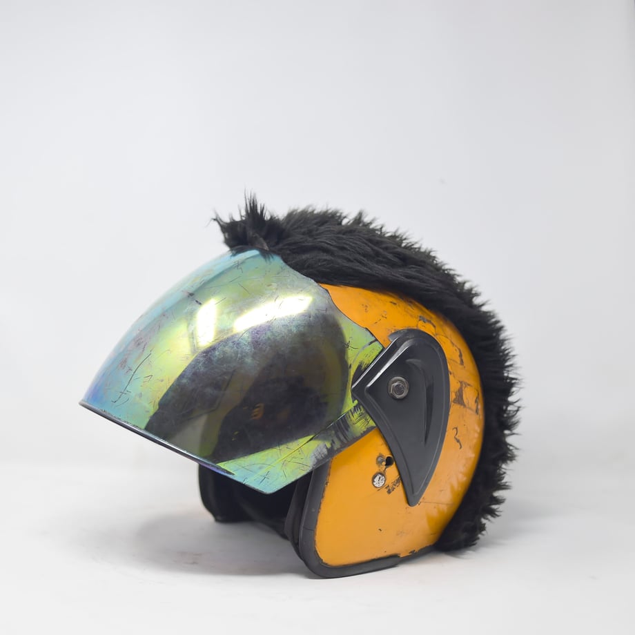 This photo by Tobin Jones shows a yellow helmet with a reflective visor and a "mohawk" of fake fur 