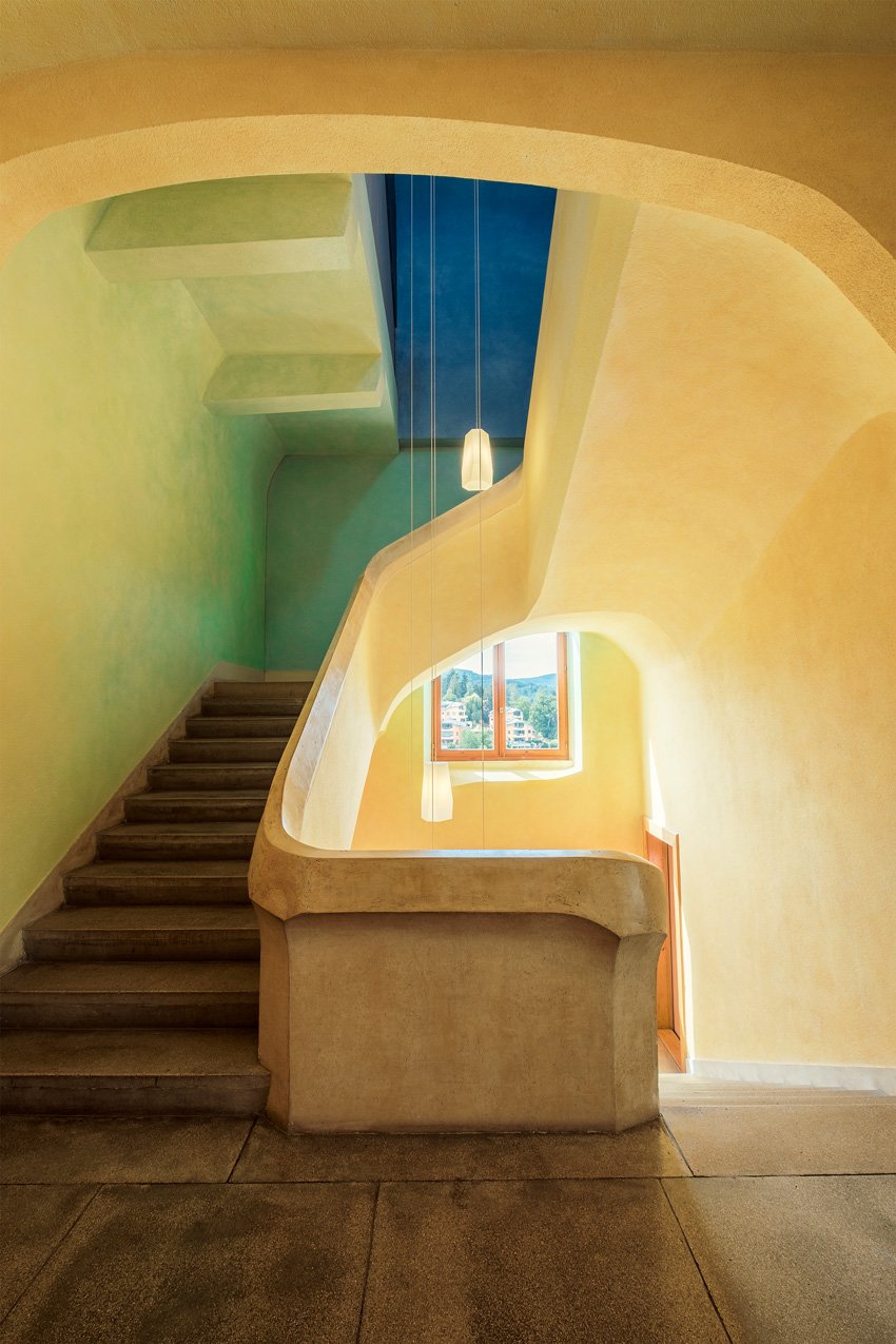 Matthias Dengler captures light streaming through a custom yellow stairwell, which lacks 90 degree angles in the architecture