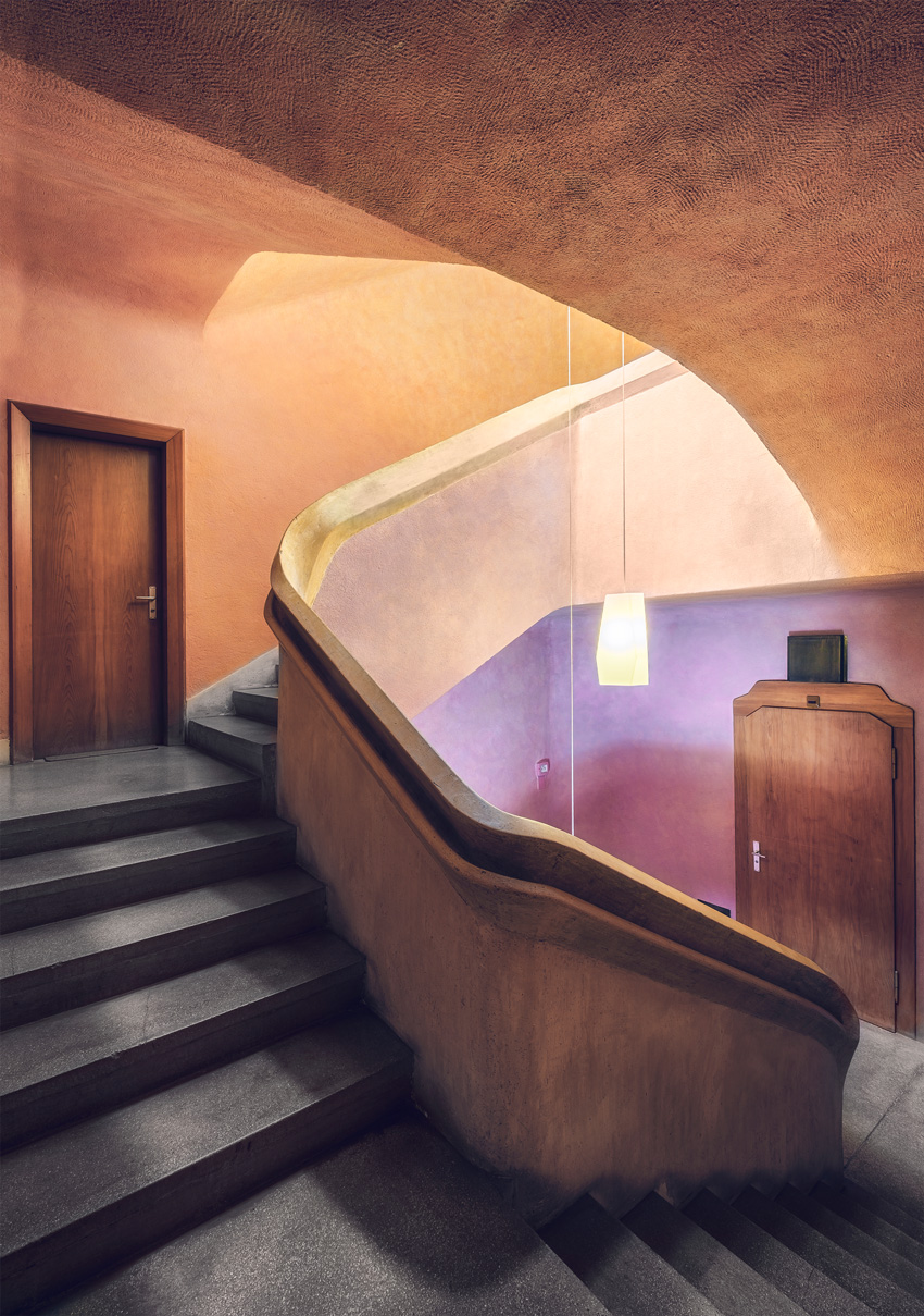 Matthias Dengler's photo of another curved stairwell, with unique doorways and purple and orange walls