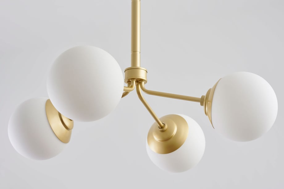 William DeShazer photographs elegant gold and white light fixture for Hunter Fan Company