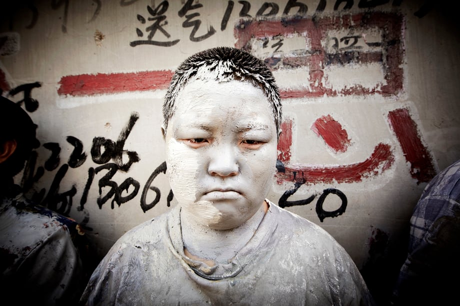 Young boy in paint as part of Liu Bolin's contemporary art piece shot by Shanghai-based portrait photographer Zachary Bako 