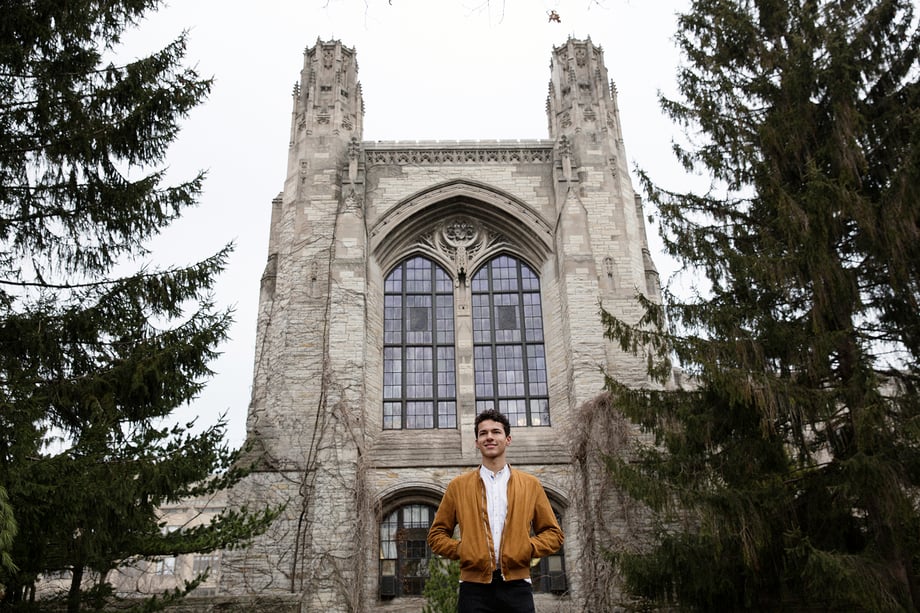 Nigel Anderson is featured by Kyle Monk standing in front of a gothic building on Northwestern's campus